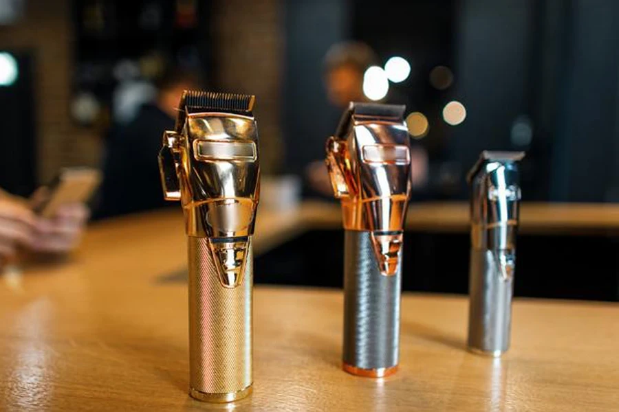 A shiny metallic vintage hair trimmer stands on a wooden table in a men's hair salon