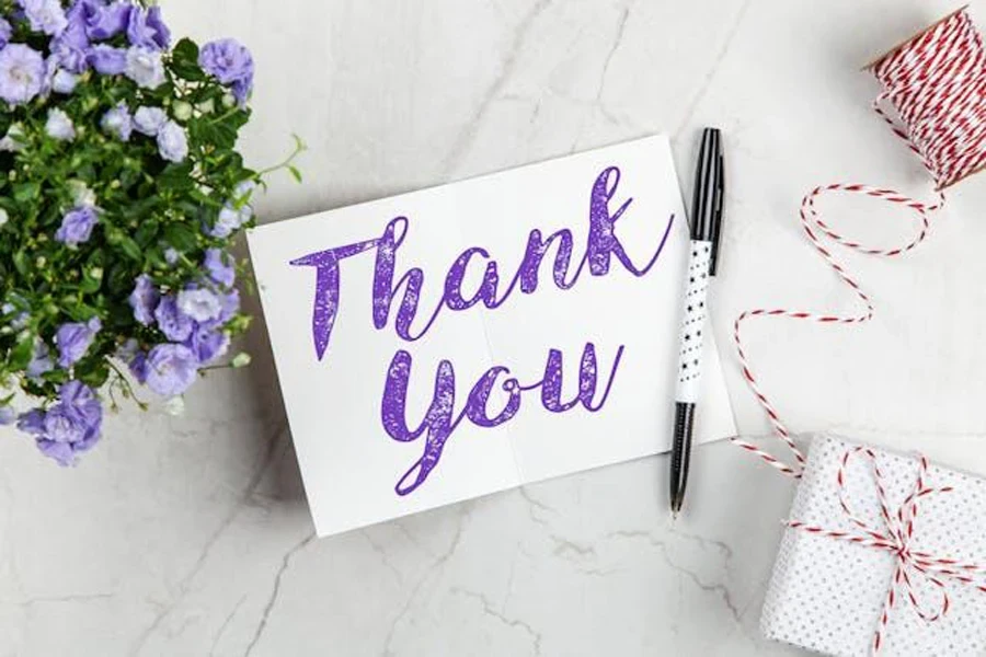 A thank-you note with a pen and gift box