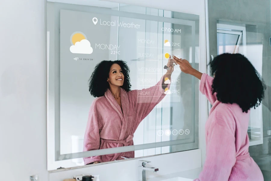 A woman looking into a smart mirror with weather updates