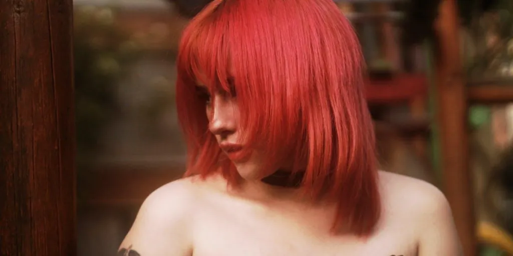 A woman with a stylish cherry red hair