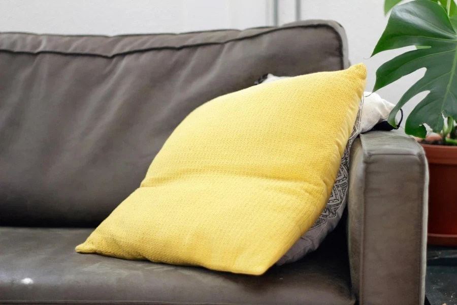 A yellow pillow on a couch