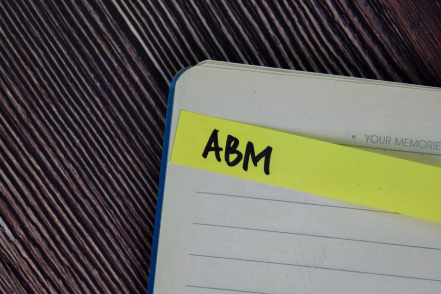 ABM written on a sticky note