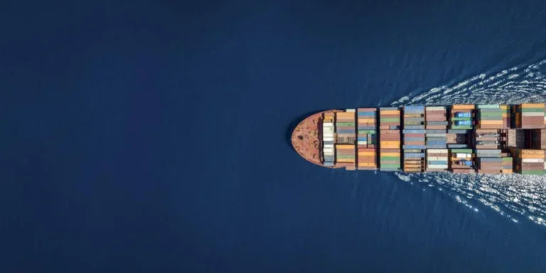 Aerial top down view of a large container cargo ship with copy space