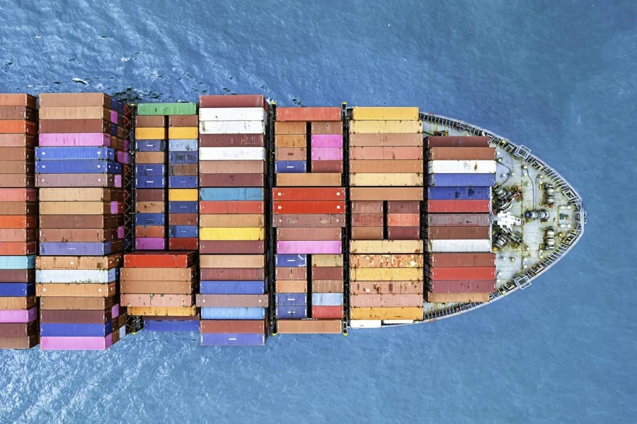 Aerial top view container ship full load container for logistics at blue sea