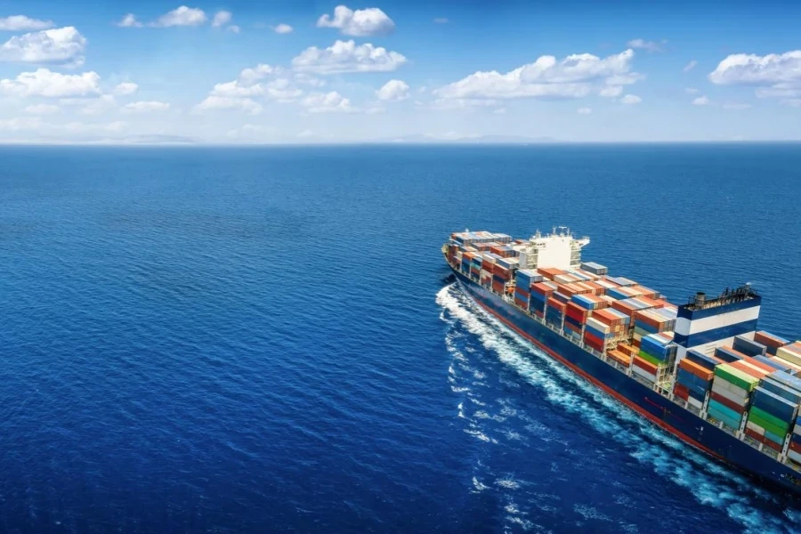 Aerial view of a large cargo ship carrying containers for import and export logistics