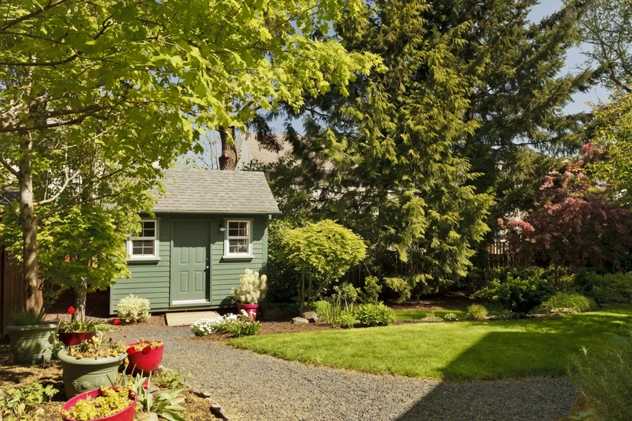 Attractive green shed surrounded by a beautiful garden