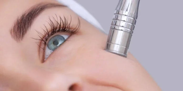 Beautician makes microdermabrasion procedure on facial skin