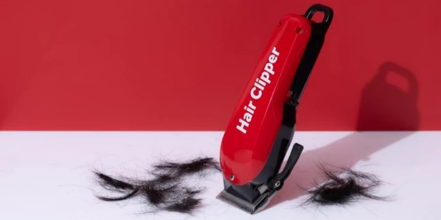 Black and red battery operated hair clippers on red background