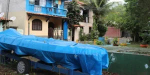 Boat under Boat Cover Parked near Residential Building