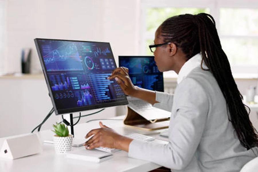 Businesswoman monitoring data on a PC