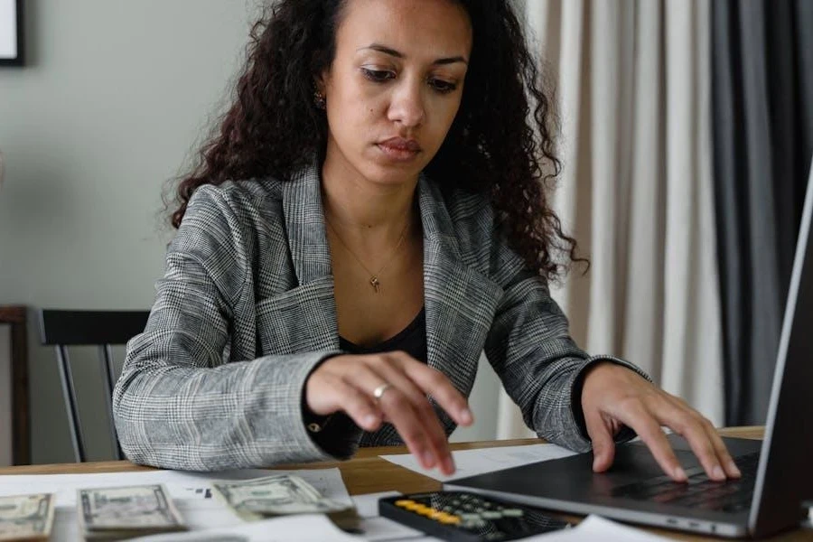 Businesswomen reevaluating petty cash on her laptop