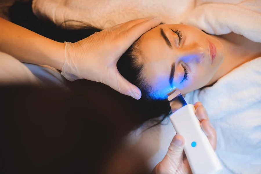 Careful dermatologist having laser session with brunette Caucasian woman