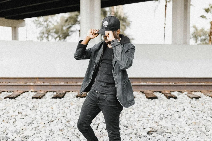 Casual Man Posing by Railway Tracks