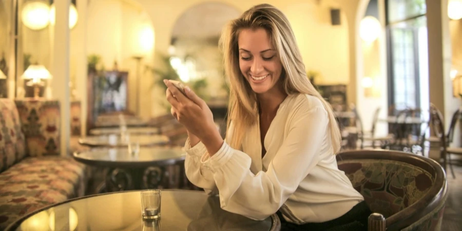 Cheerful female having drink in elegant bar