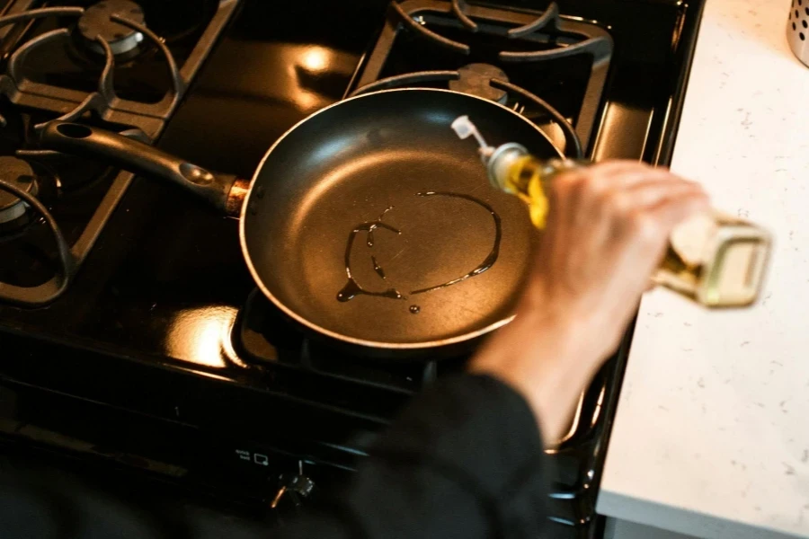 Chef Pours Oil into Pan