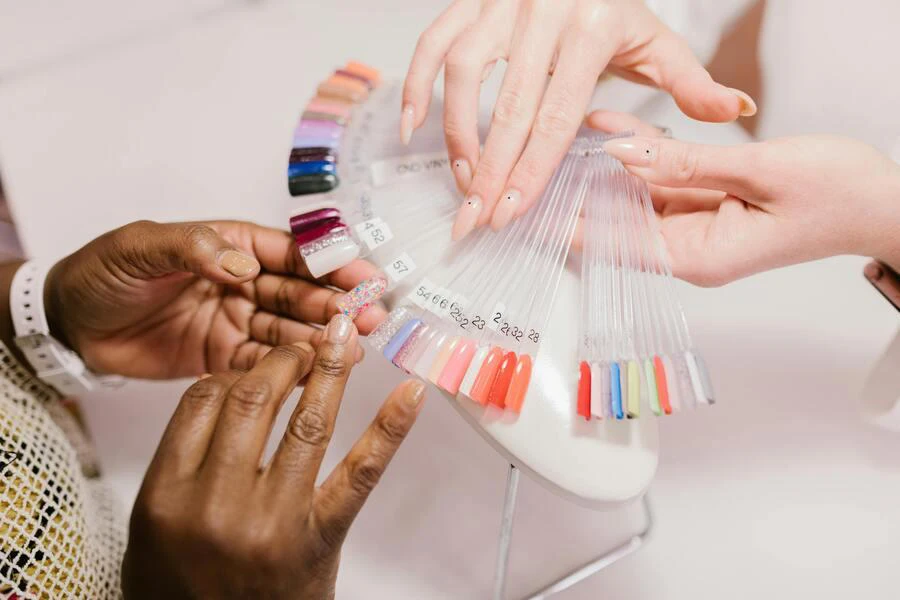 Client choosing nails from a nail color pallette