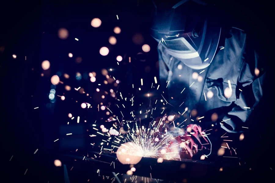 Employee welding steel