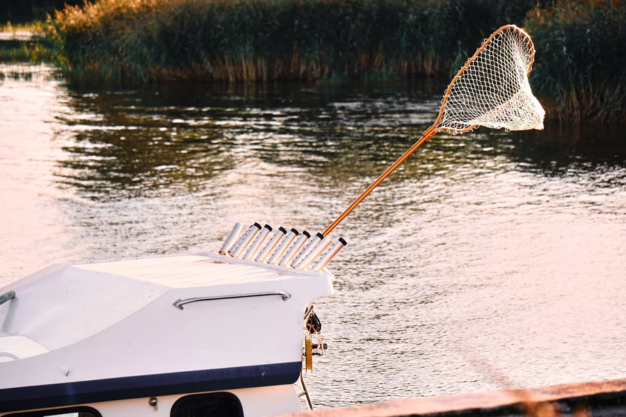 Fishing net on boat for trout fishing at sunrise