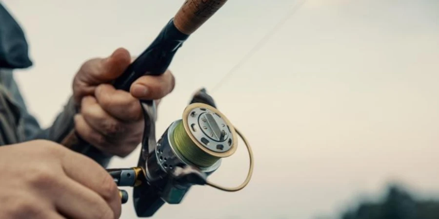 Fishing rod with spinning reel in the hands of a fisherman