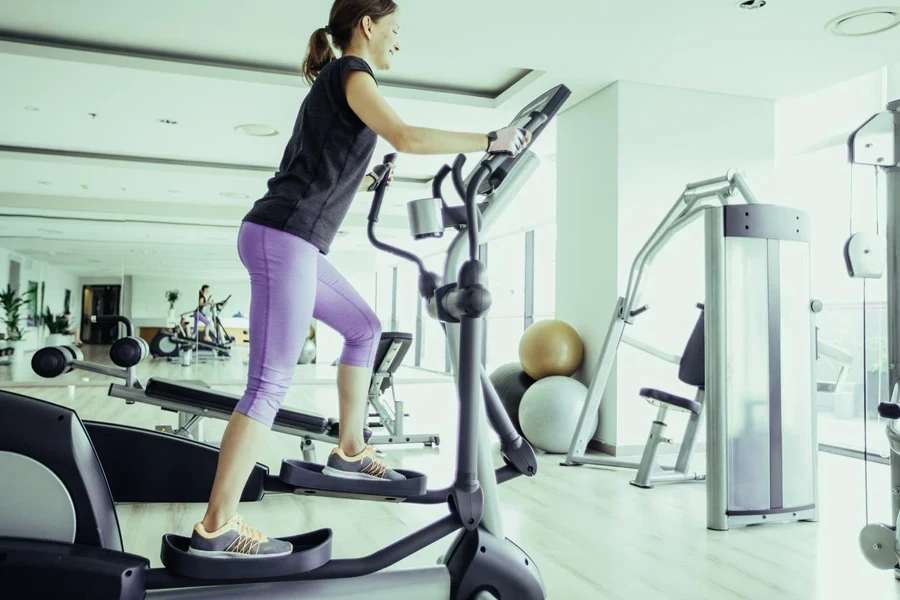 Girl Training on Stair Stepper in Gym