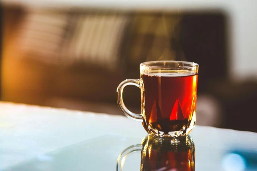 Glass mug filled with black tea