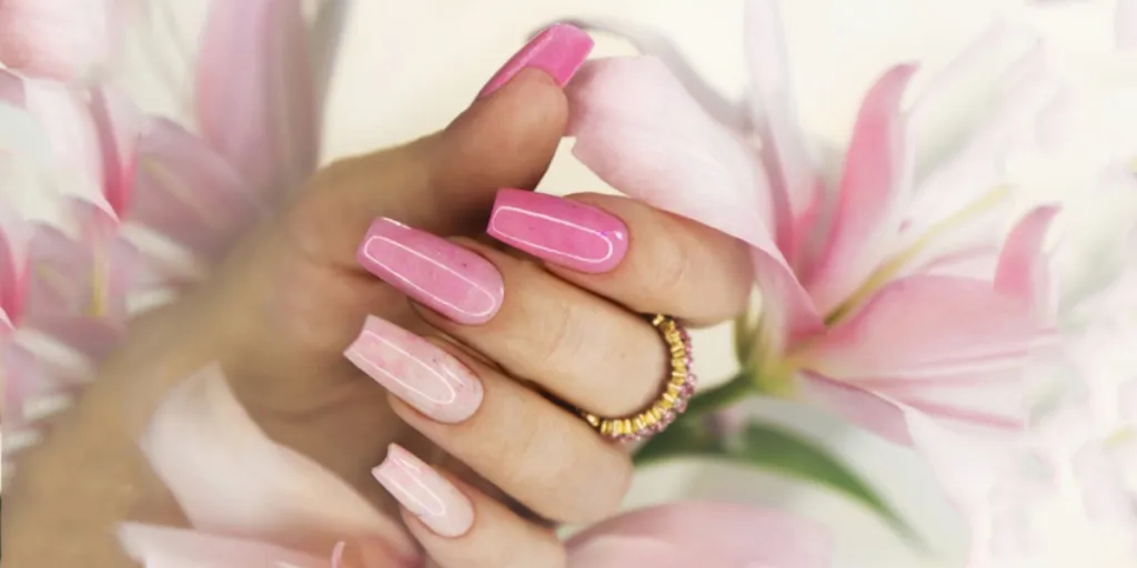 Hand with pink acrylic nails