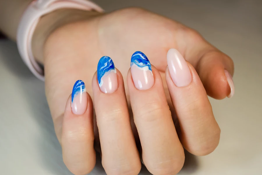 Hand with pink and blue acrylic nails