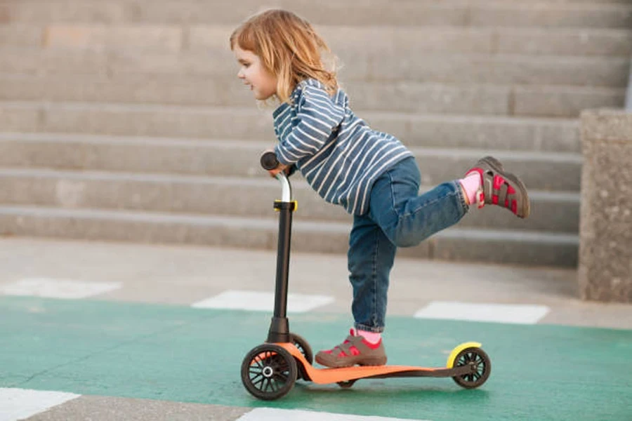 Happy Positive Child on the Scooter in the City