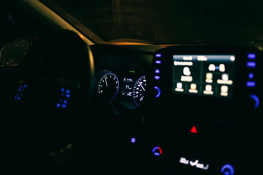 Illuminated dashboard of contemporary car parked on street in evening