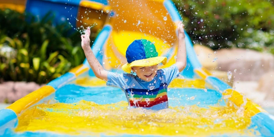 Kids on water slide in aqua park.