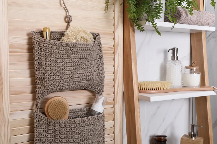 Knitted hanging basket beside a ladder shelf in the bathroom