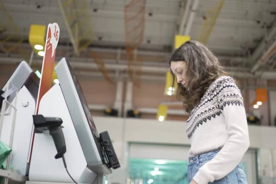 Lady at a self-checkout lane