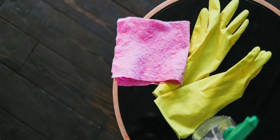 Latex Gloves and Cleaning products Placed on Table in Room