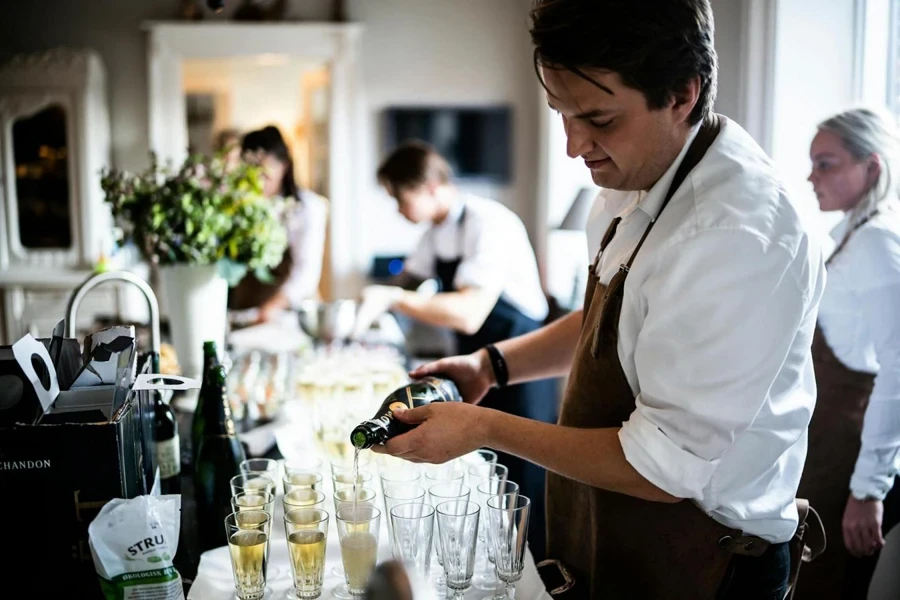 Man Pouring Wine on Glasses