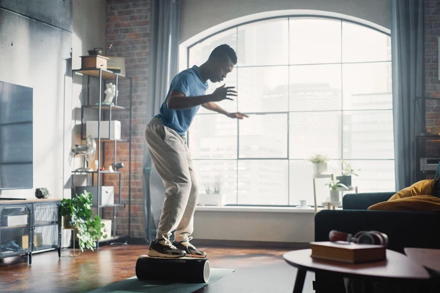 Man Training on the Balance Board at Home