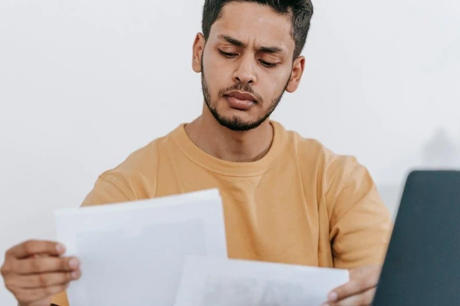 Man looking through documents to decide what to offer