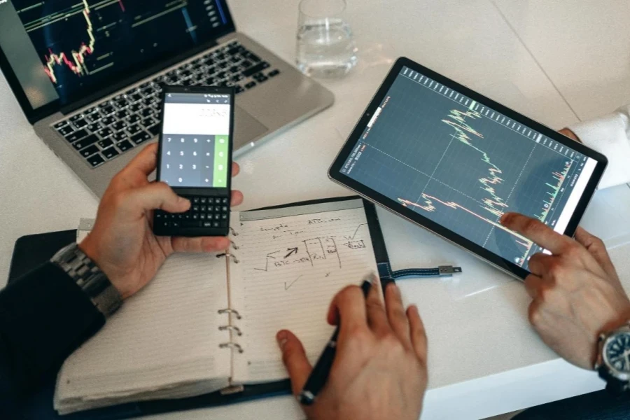 People Analyzing Data on a Digital Tablet