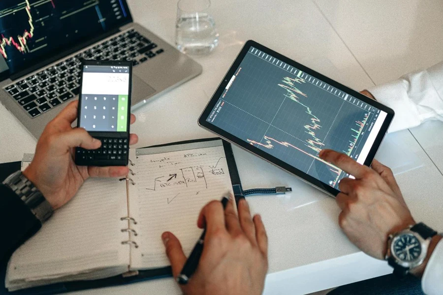 People Analyzing Data on a Digital Tablet