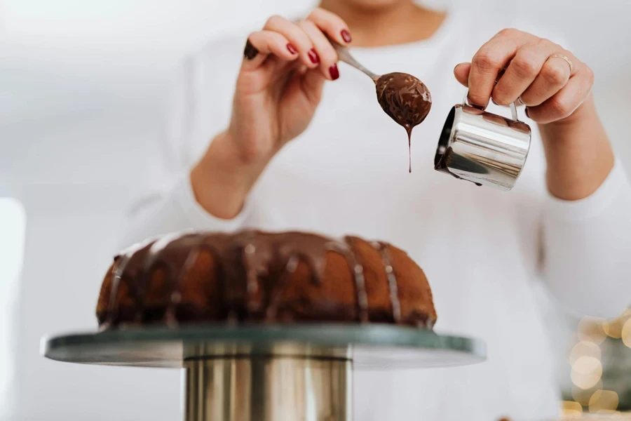 Person Decorating Cake with Chocolate