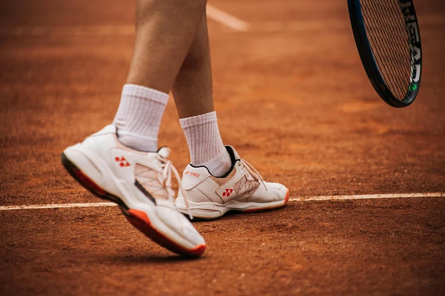 Person Wearing White and Red Sneakers