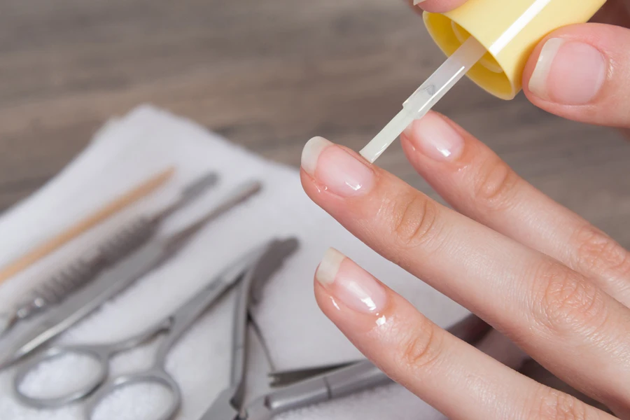 Person applying cuticle oil