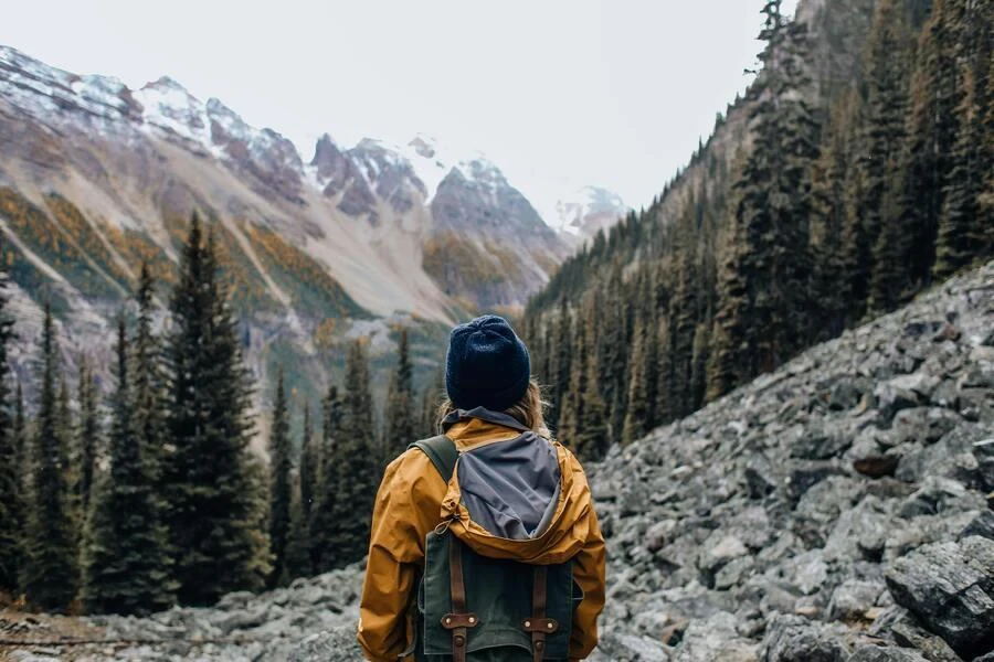 Person carrying a compressed daypack on mountainside