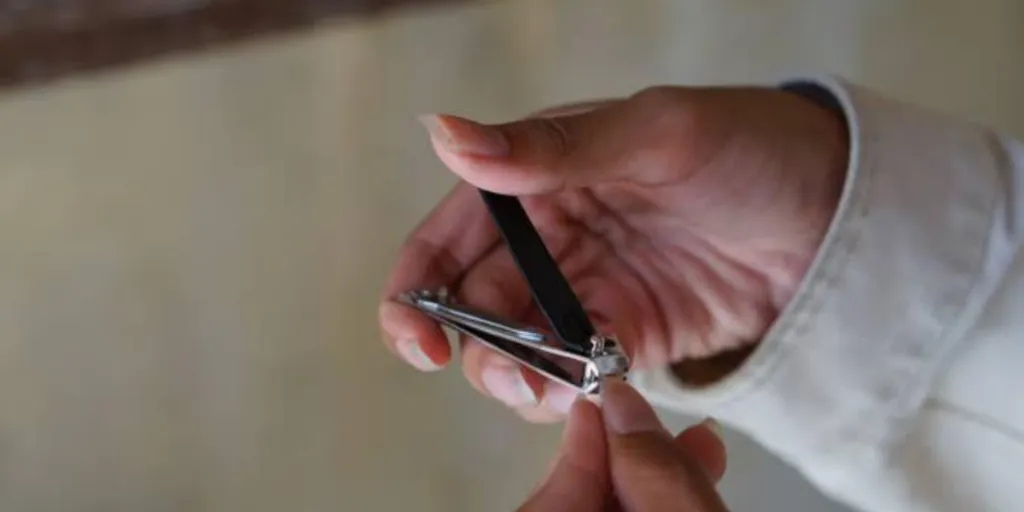 Person cutting nails with a clipper