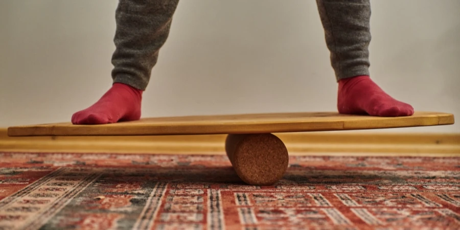 Person standing on a wooden balance board