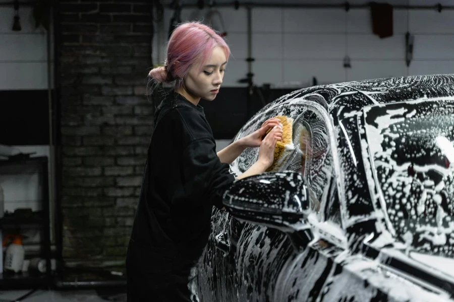 Photo of a Woman Rubbing the Window of a Car