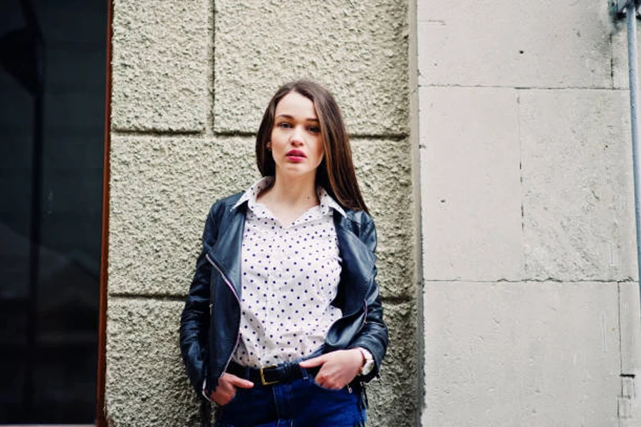 Portrait of Stylish Young Girl Wear on Leather Jacket and Ripped Jeans at Streets of City