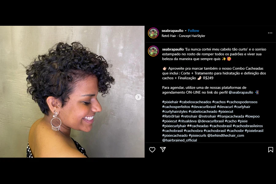 Screenshot of a smiling woman rocking a pixie curl