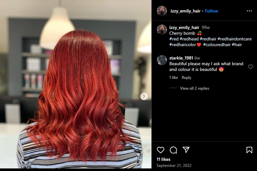 Screenshot of a woman with bright cherry hair