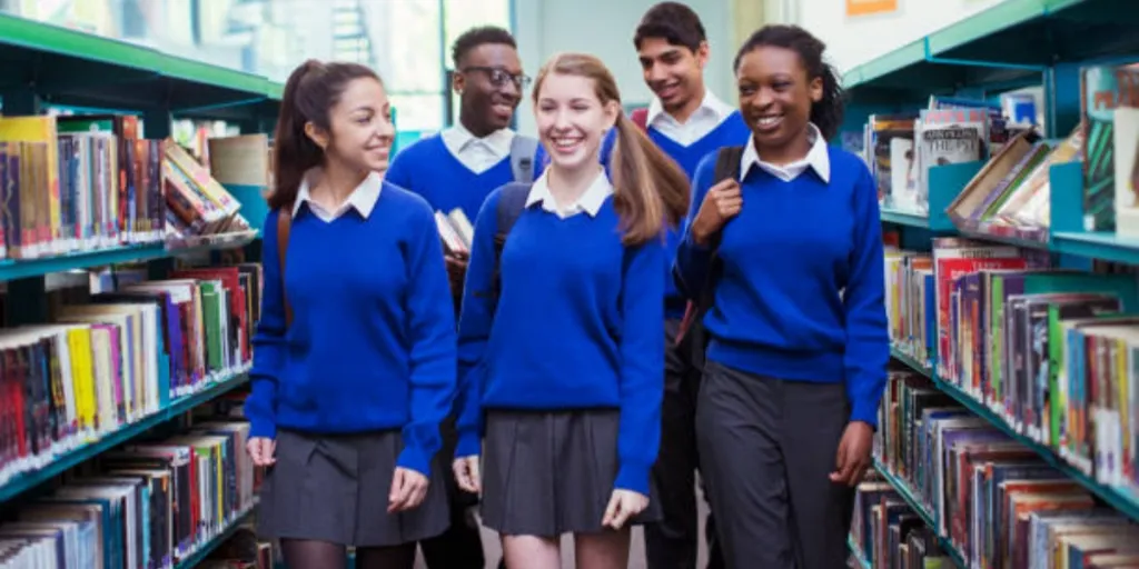 Secondary school students in a library wearing school uniforms