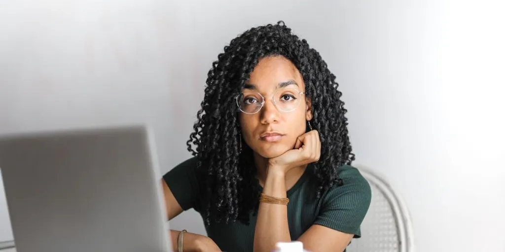 Serious black woman rocking a curly bob